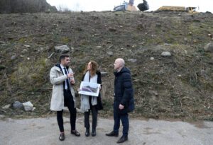 Tres personas discutiendo sobre las obras de una estación transformadora en el Riu Runer.