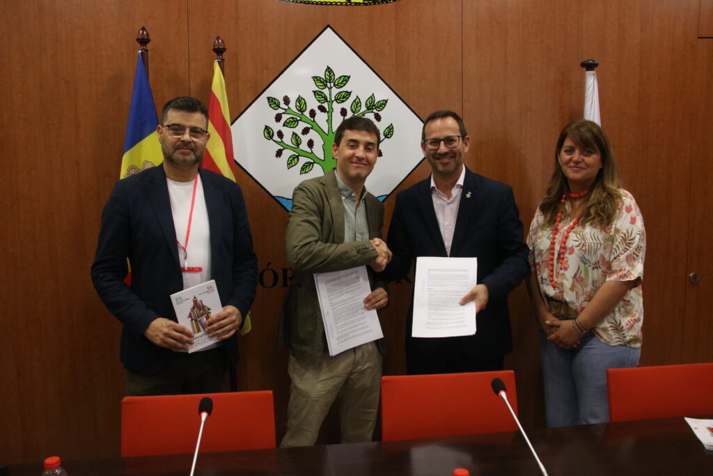 Representantes firmando un acuerdo para promover artistas andorrans en la Fira Litterarum.