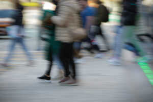 Personas caminando en una calle con movimiento difuminado