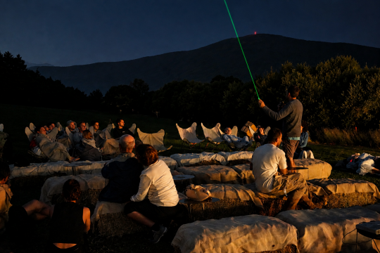 Grupo de personas observando el cielo nocturno con telescopios